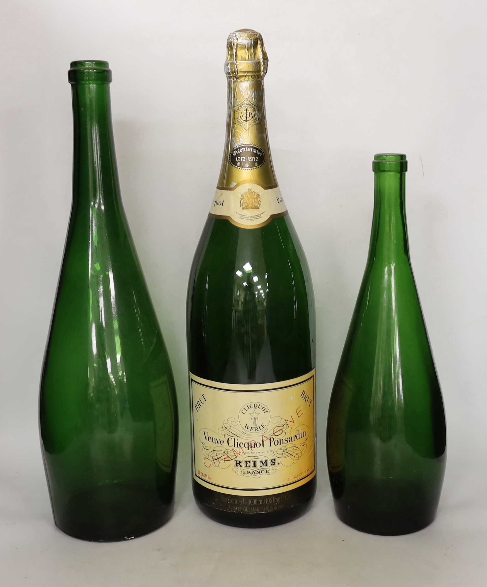 A group of five bottles including a vacant double magnum Veuve Clicquot Ponsardin bottle